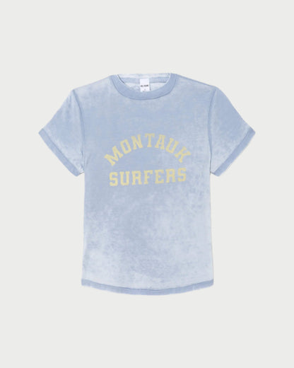 The RE/DONE Montauk Tee is a light blue, short-sleeve vintage-inspired shirt with rolled cuffs and "MONTAUK SURFERS" in yellow on the front, crafted from soft organic cotton for a casual look.