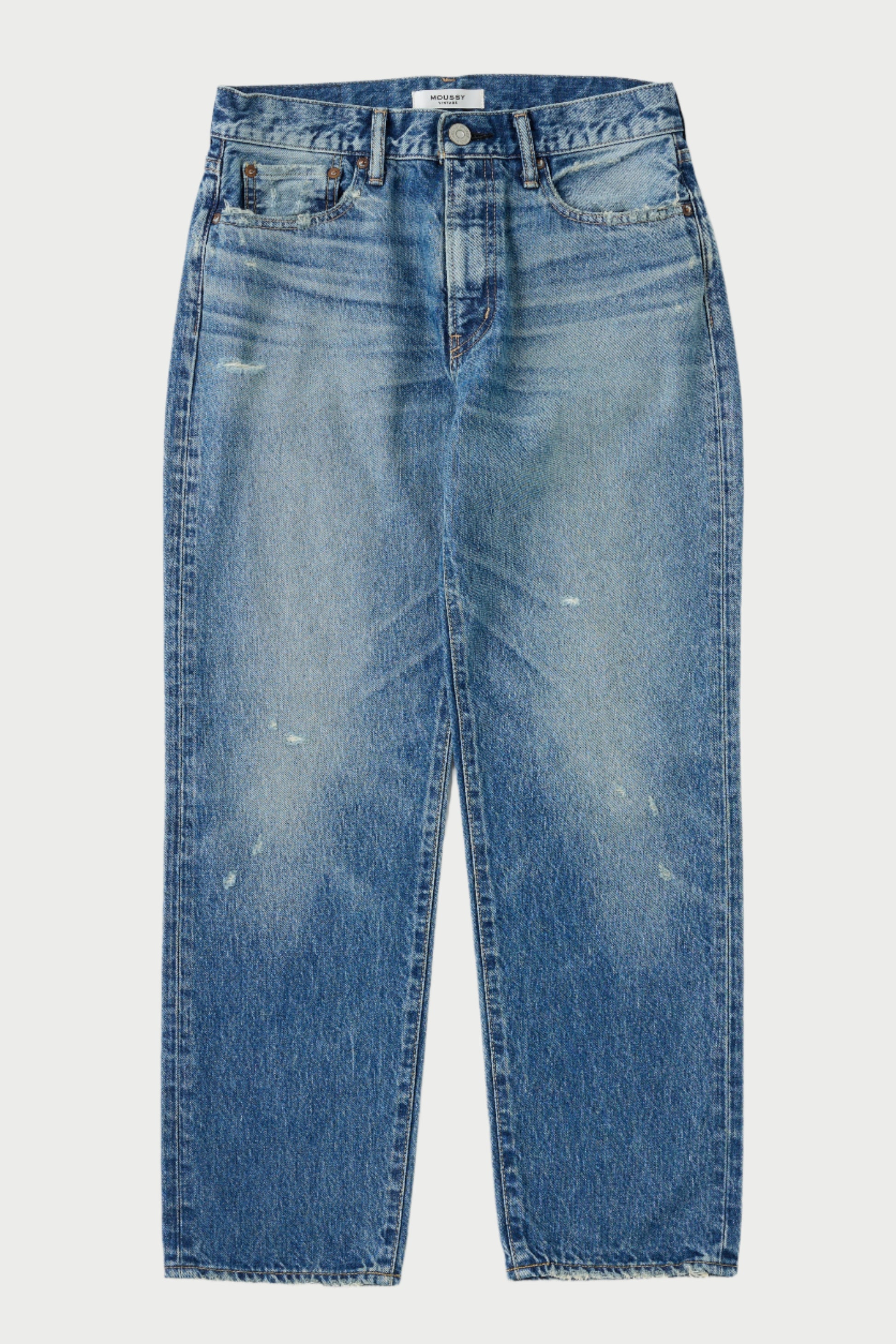 Blue jeans with slight distressing on a white background