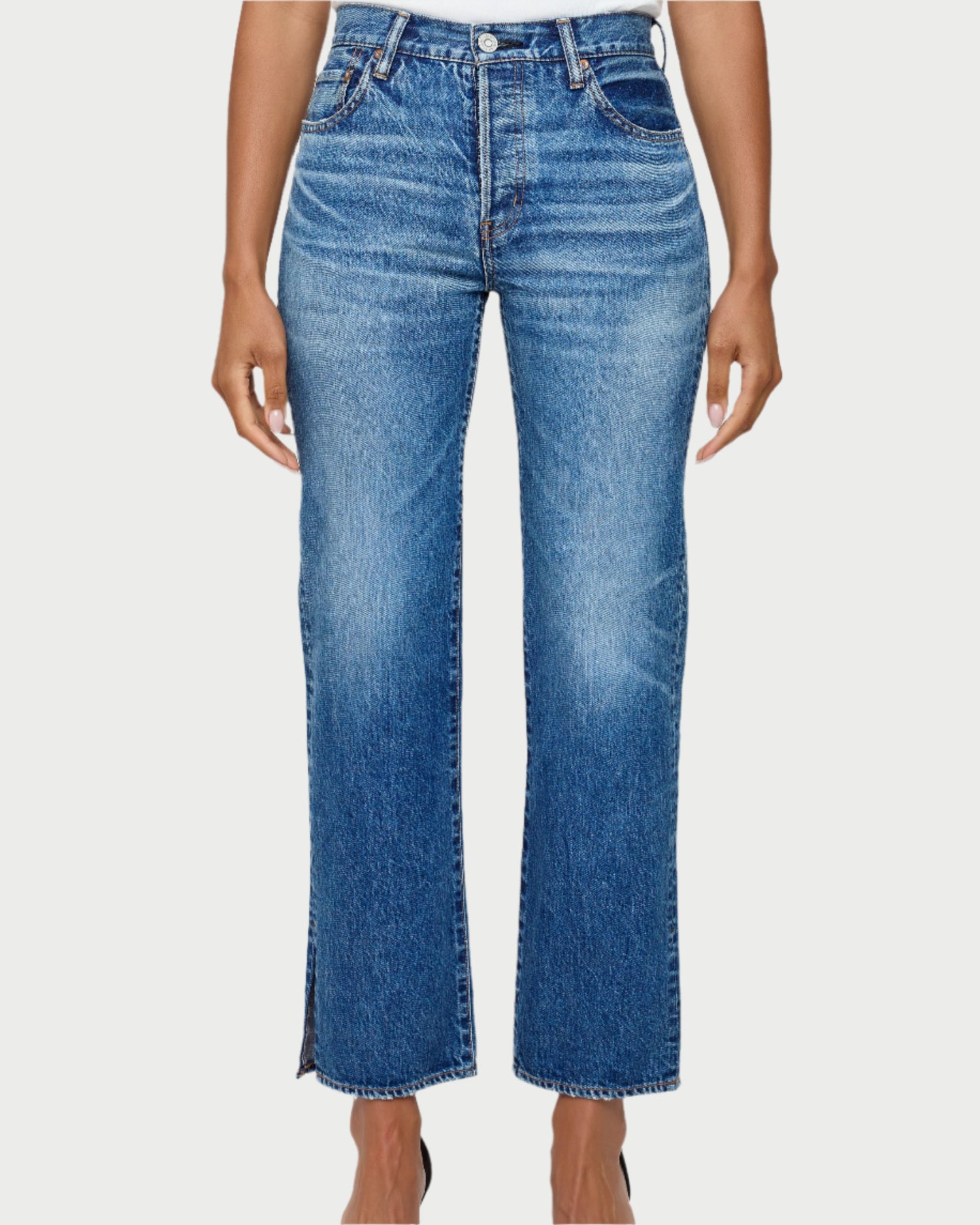 A person wears Moussy Sunset Straight Jeans by Moussy, made from Japanese cotton denim with a faded wash and slight flare at the hem, standing against a white background with hands relaxed at their sides.