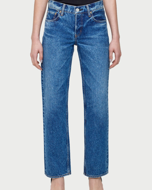Person wearing blue jeans on a white background