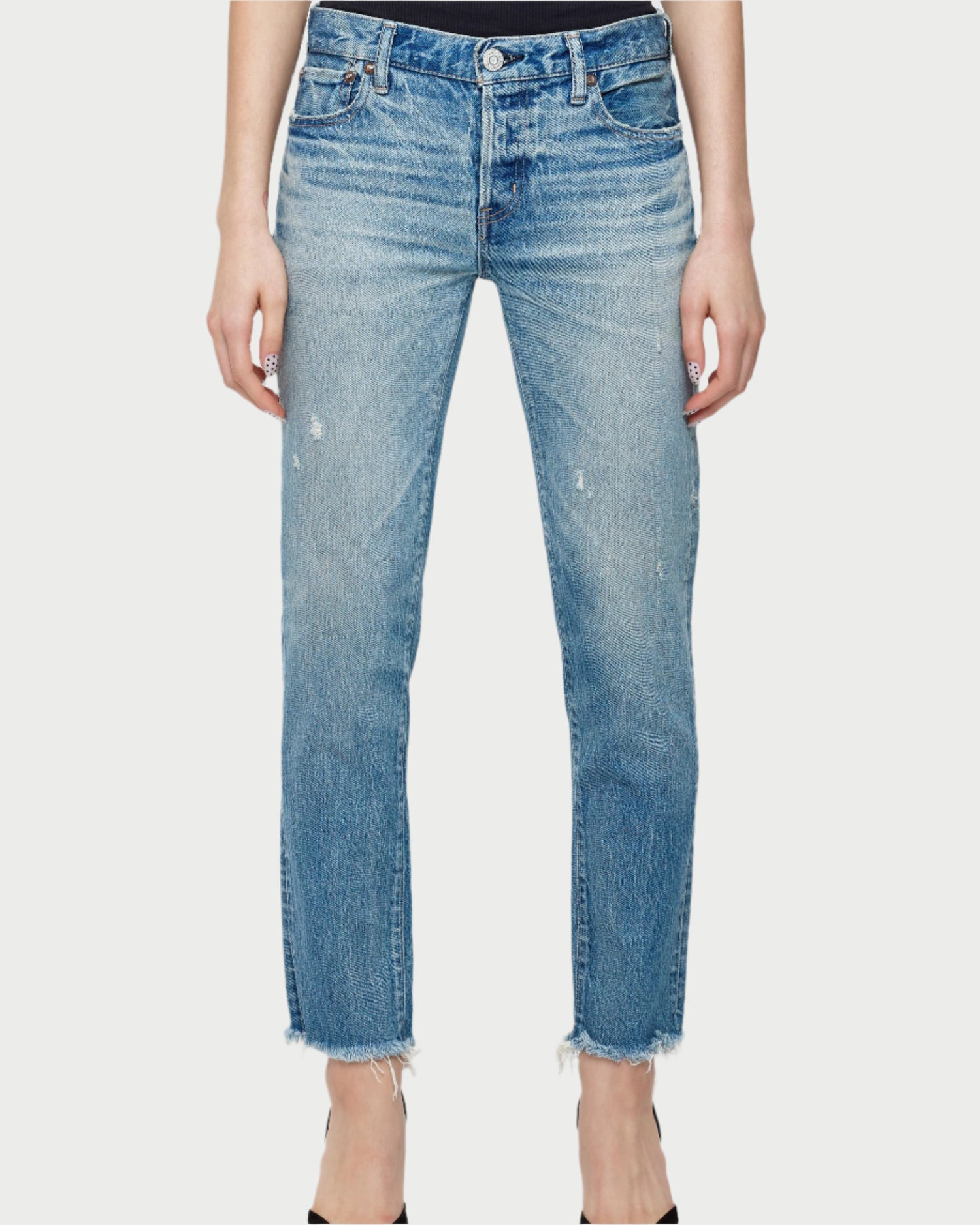 A person wears Moussy Bretton Tapered Jeans in light blue distressed Japanese denim. Featuring a mid-rise, straight-leg fit with frayed hems, classic five-pocket design, and button closure. Hands at sides, feet partially visible.