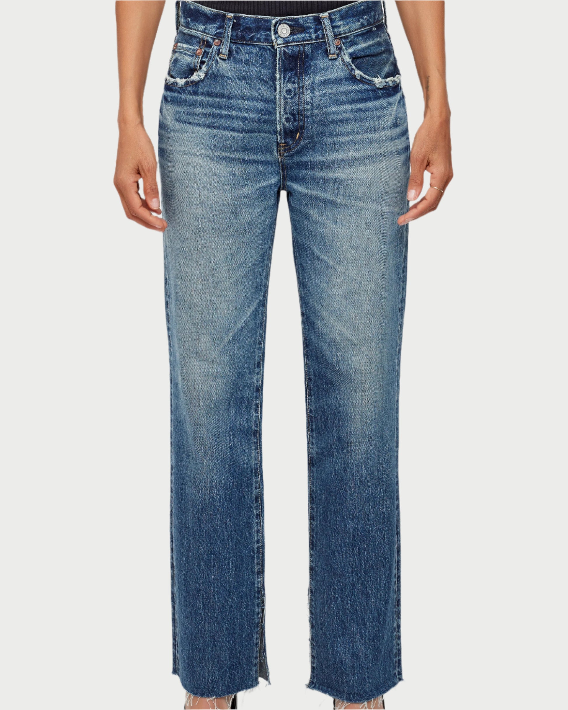 Person wearing blue jeans on a white background