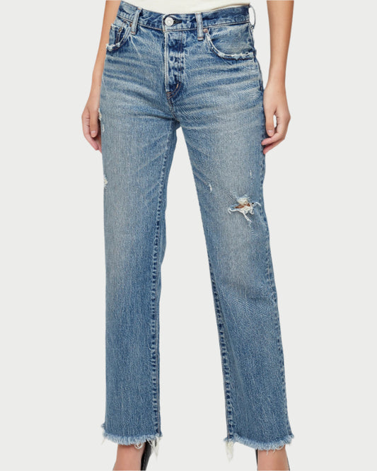 Blue jeans worn by a person on a white background