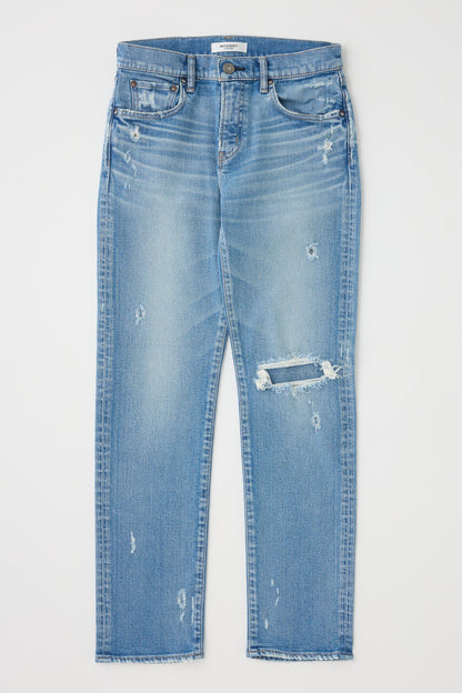Blue jeans with slight distressing on a light gray background