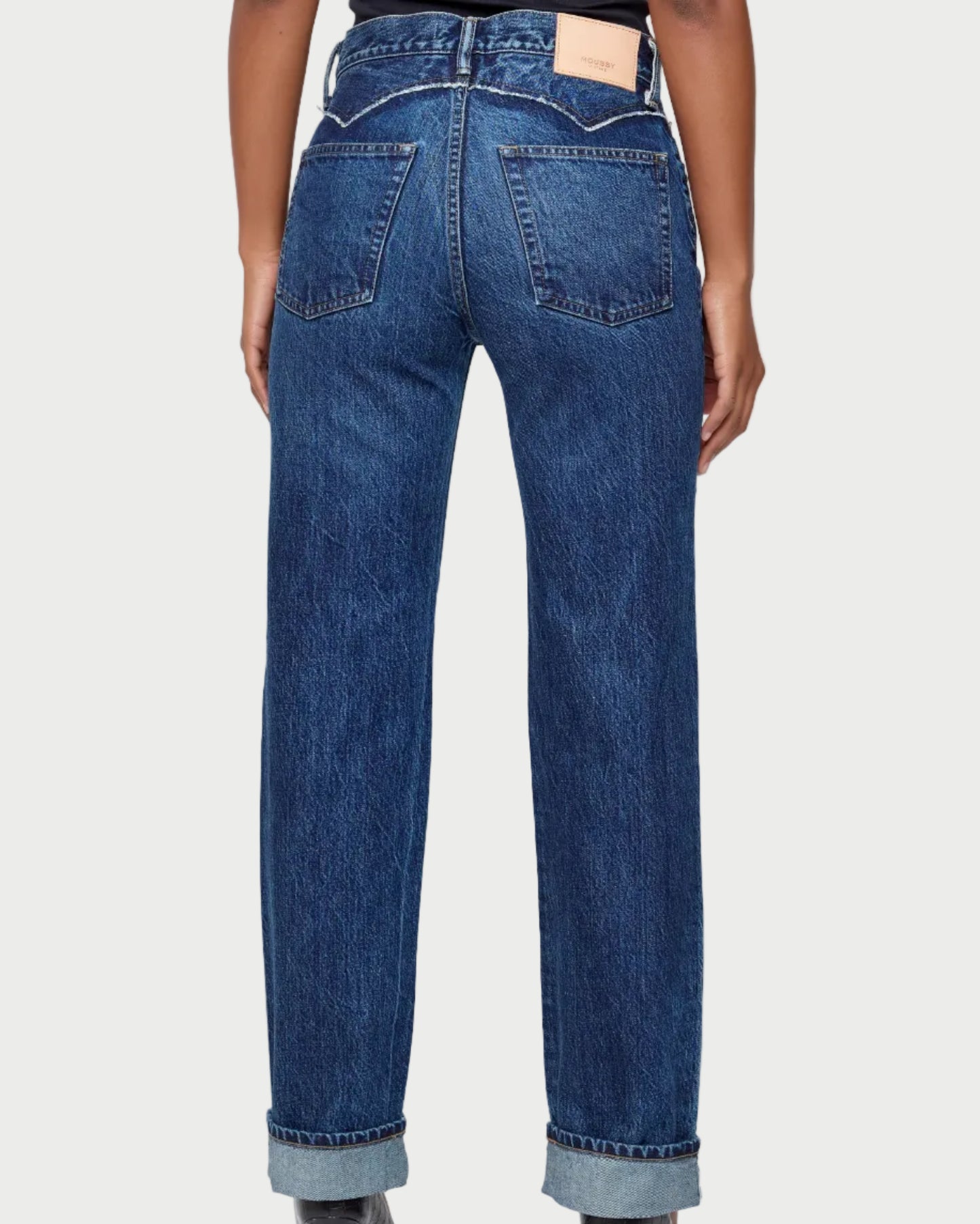Person wearing blue jeans on a white background