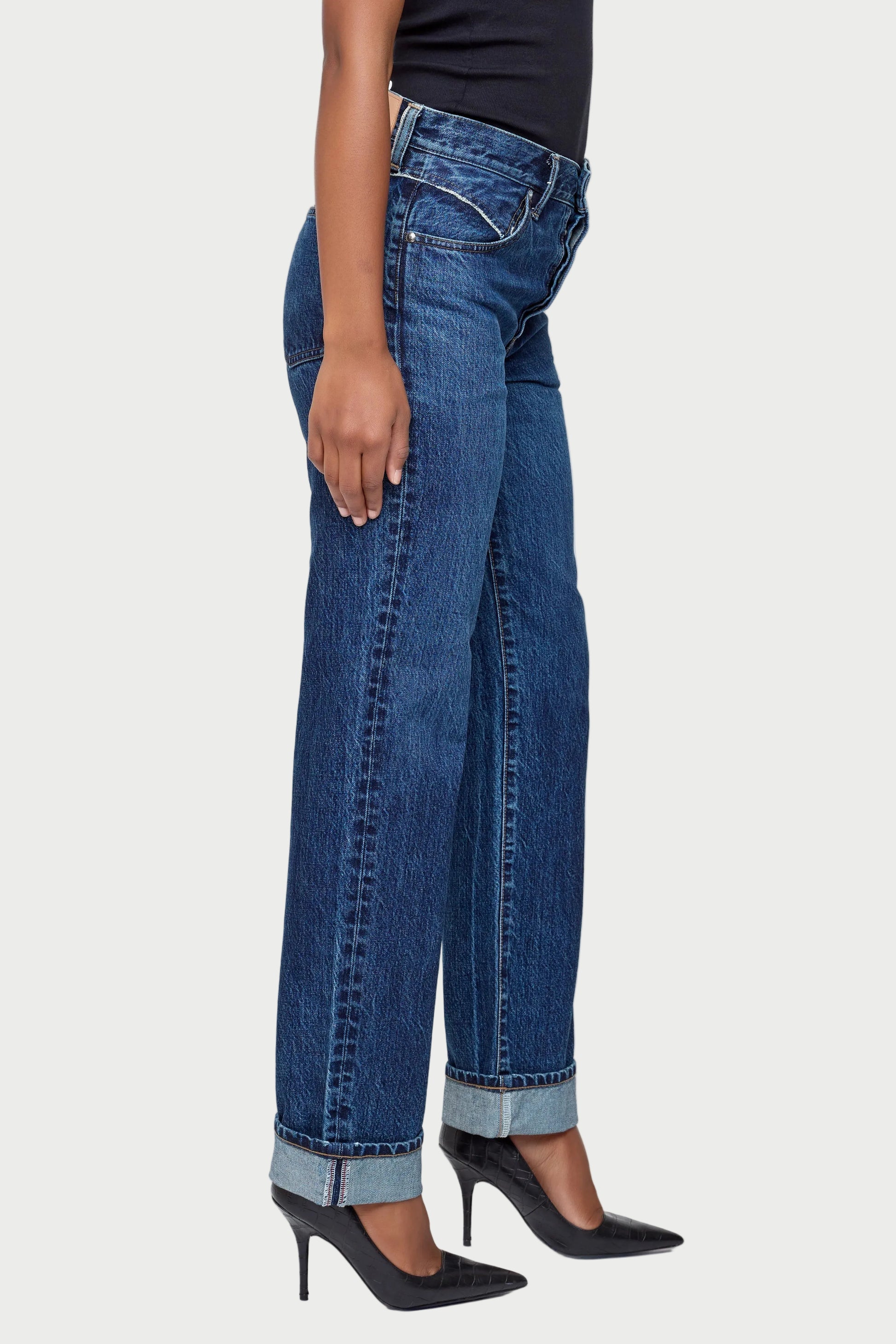 Person wearing blue jeans on a white background
