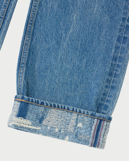Close-up of blue denim jeans with a white background