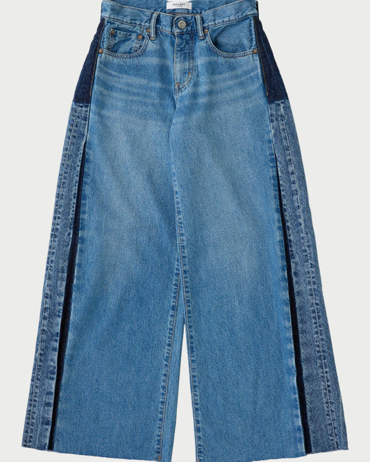 Blue jeans with black side panels on a white background