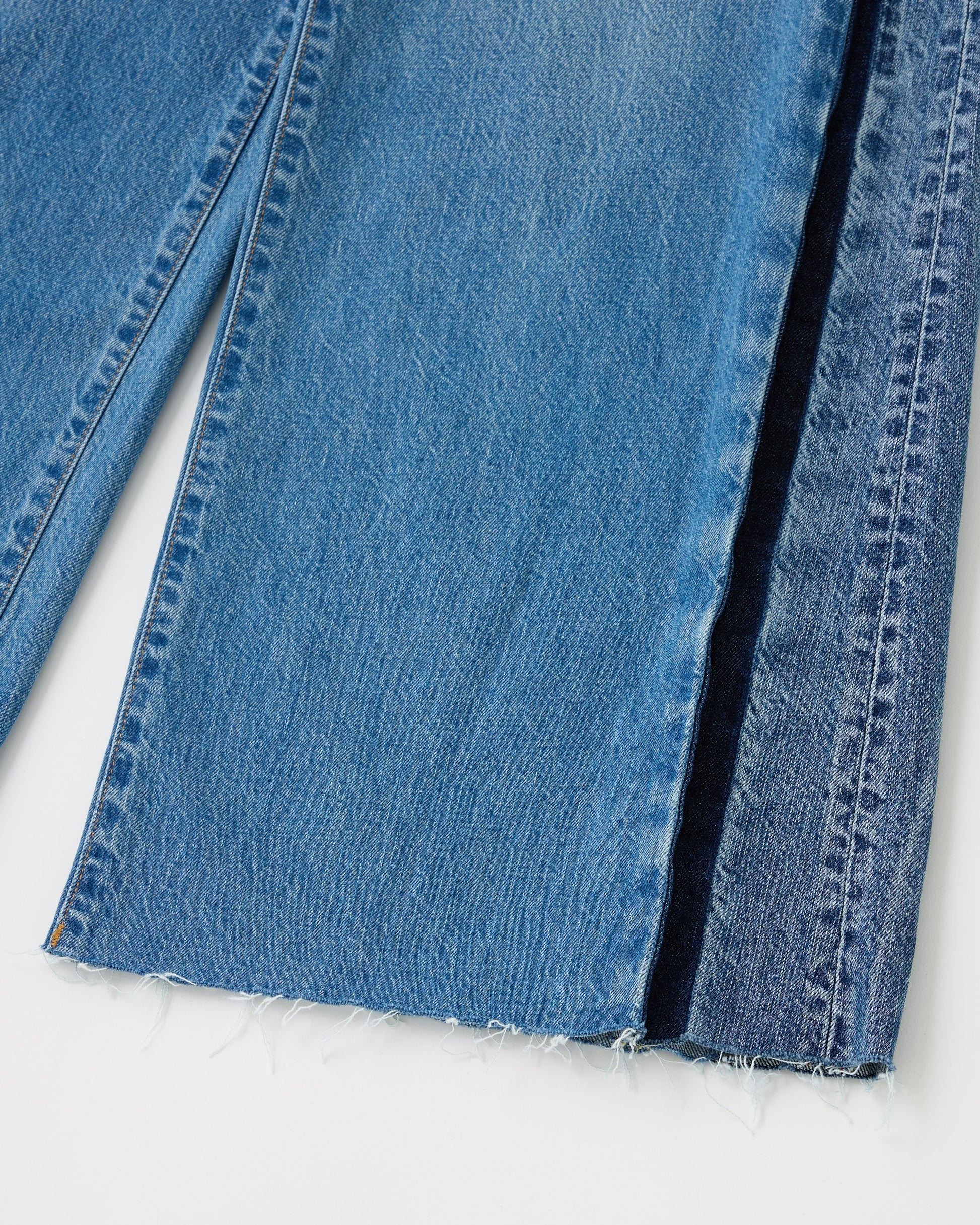 Close-up of blue denim fabric on a white background