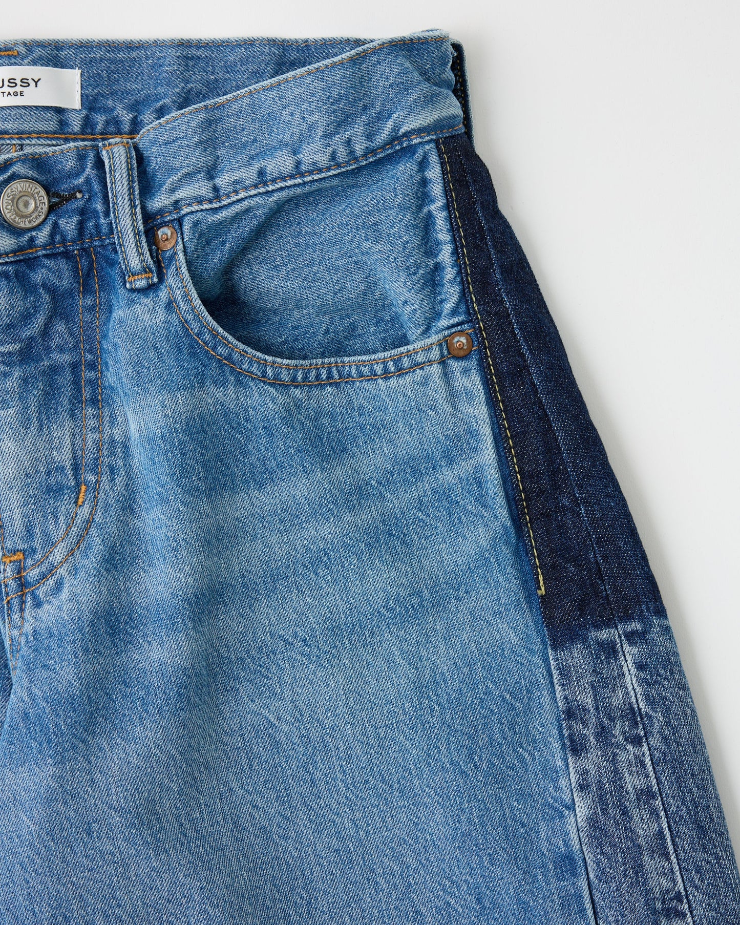 Close-up of blue jeans with a white background