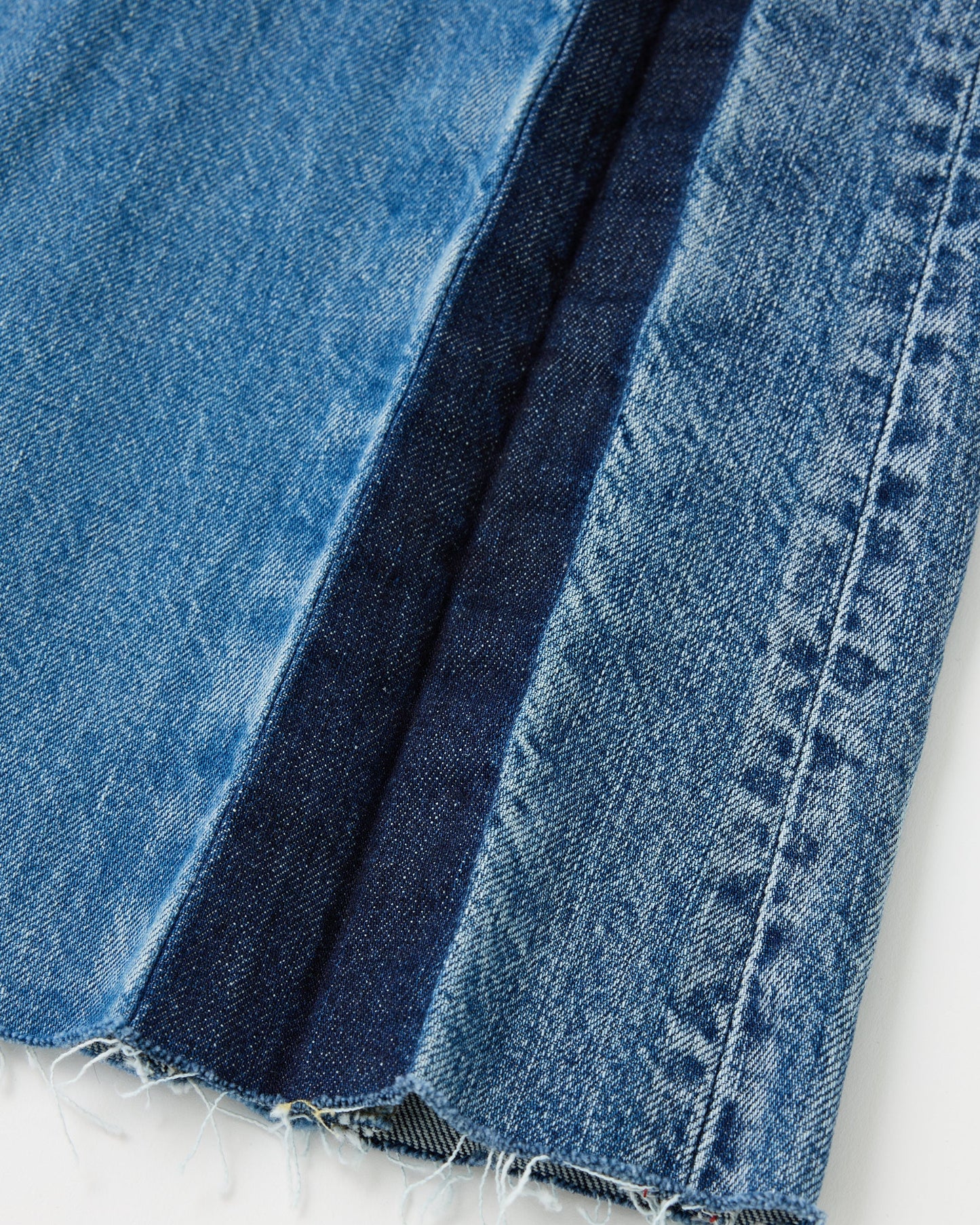 Close-up of blue denim fabric on a white background