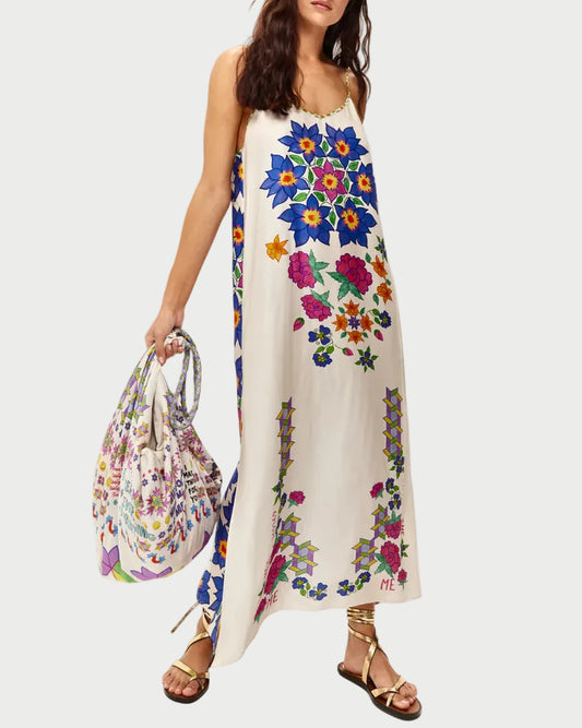 Woman wearing a floral dress holding a matching handbag on a white background