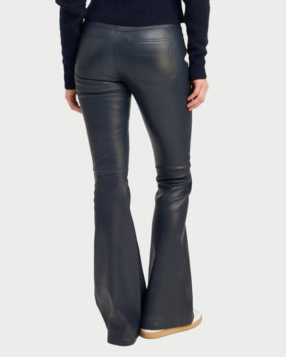 Midnight leather flared pants worn by a person on a white background
