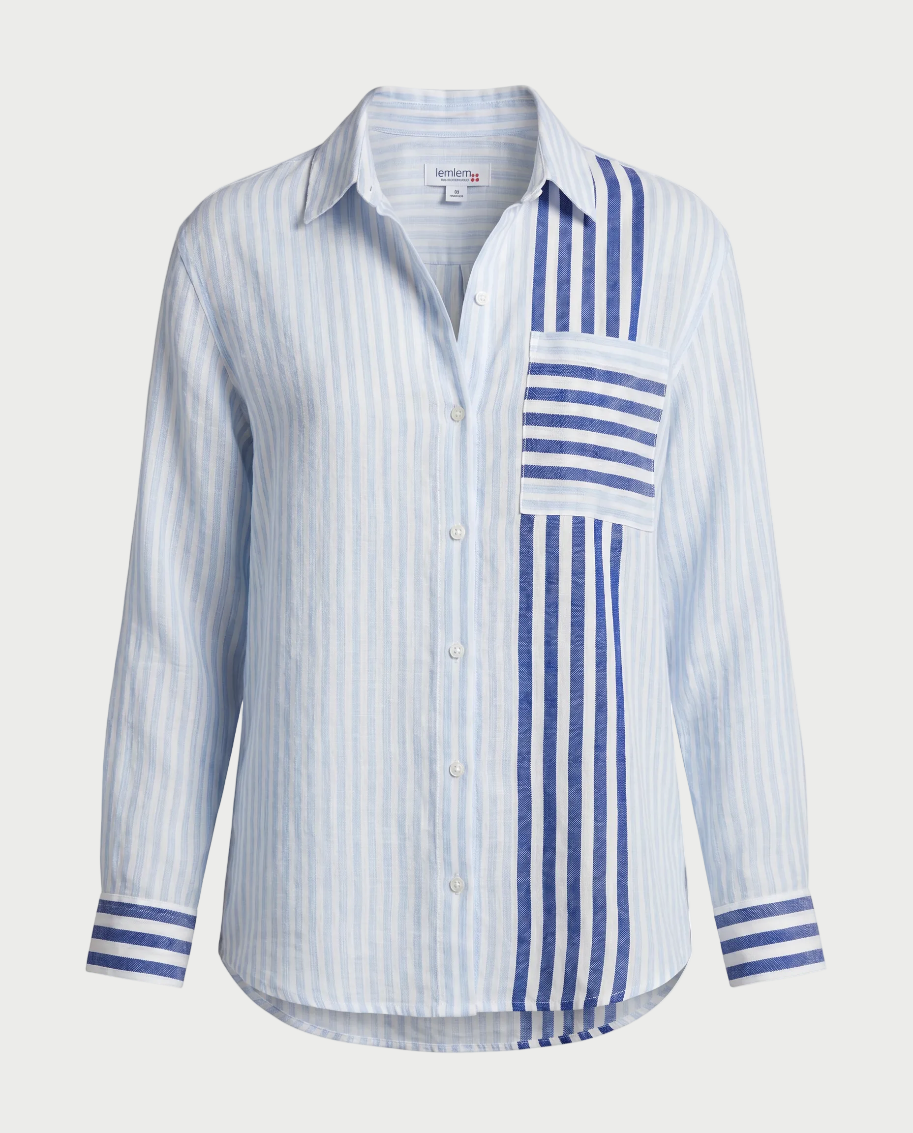 The LemLem Aisha Shirt is a relaxed, handwoven cotton button-down in light blue and white stripes with bold navy and white accents on the pocket, shoulder, and cuffs. Inspired by the Lemlem Aisha collection.