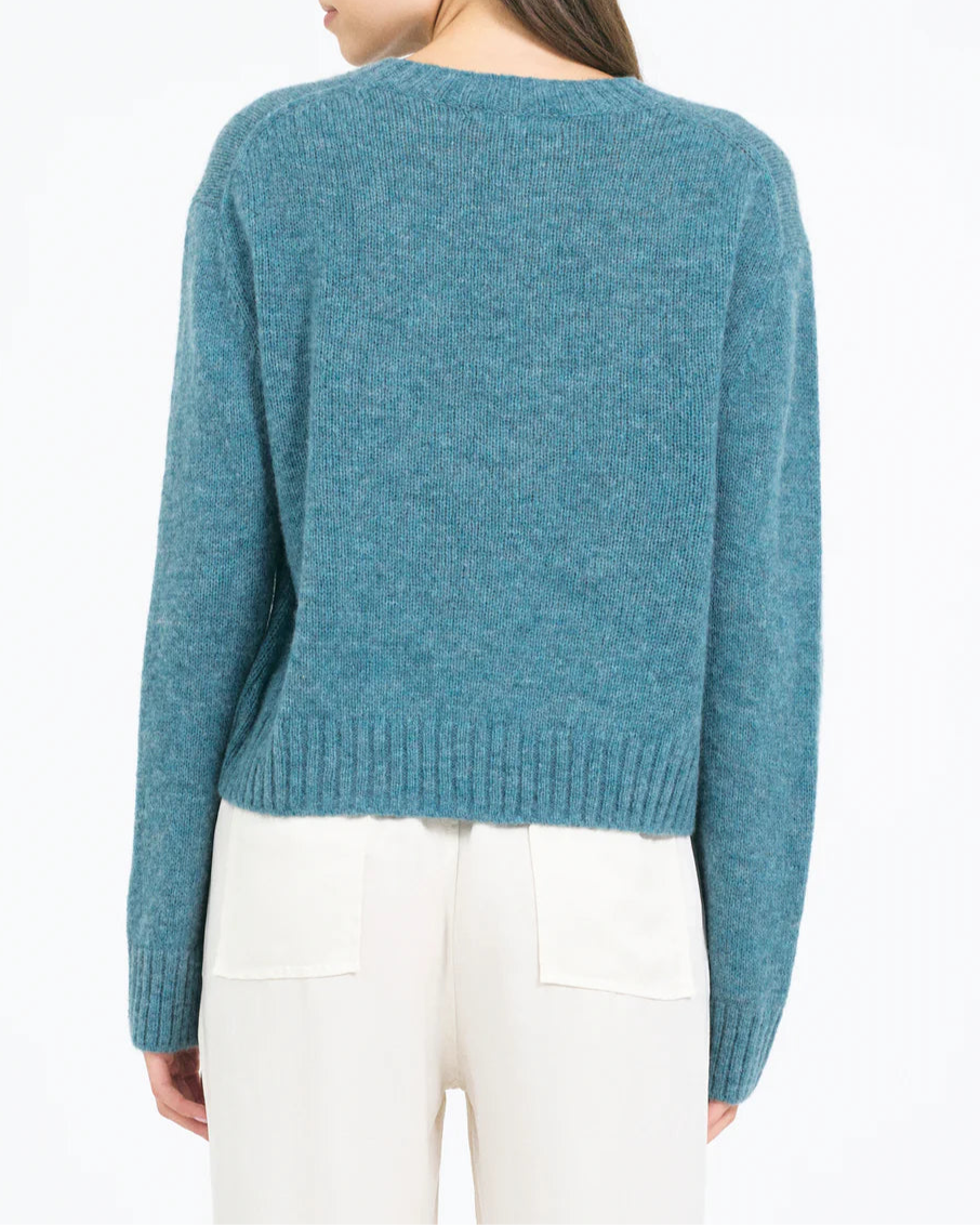 Woman wearing a blue sweater on a white background