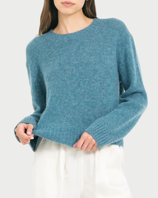 Woman wearing a blue sweater on a white background