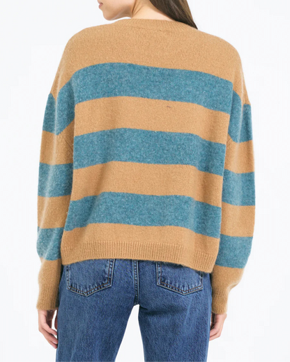 A person wears the One Grey Day Sophie Pullover—a relaxed fit, long-sleeve sweater with wide tan and teal stripes—paired with blue jeans, seen from the back against a plain white background.