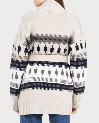 Person wearing a patterned cardigan with a white background