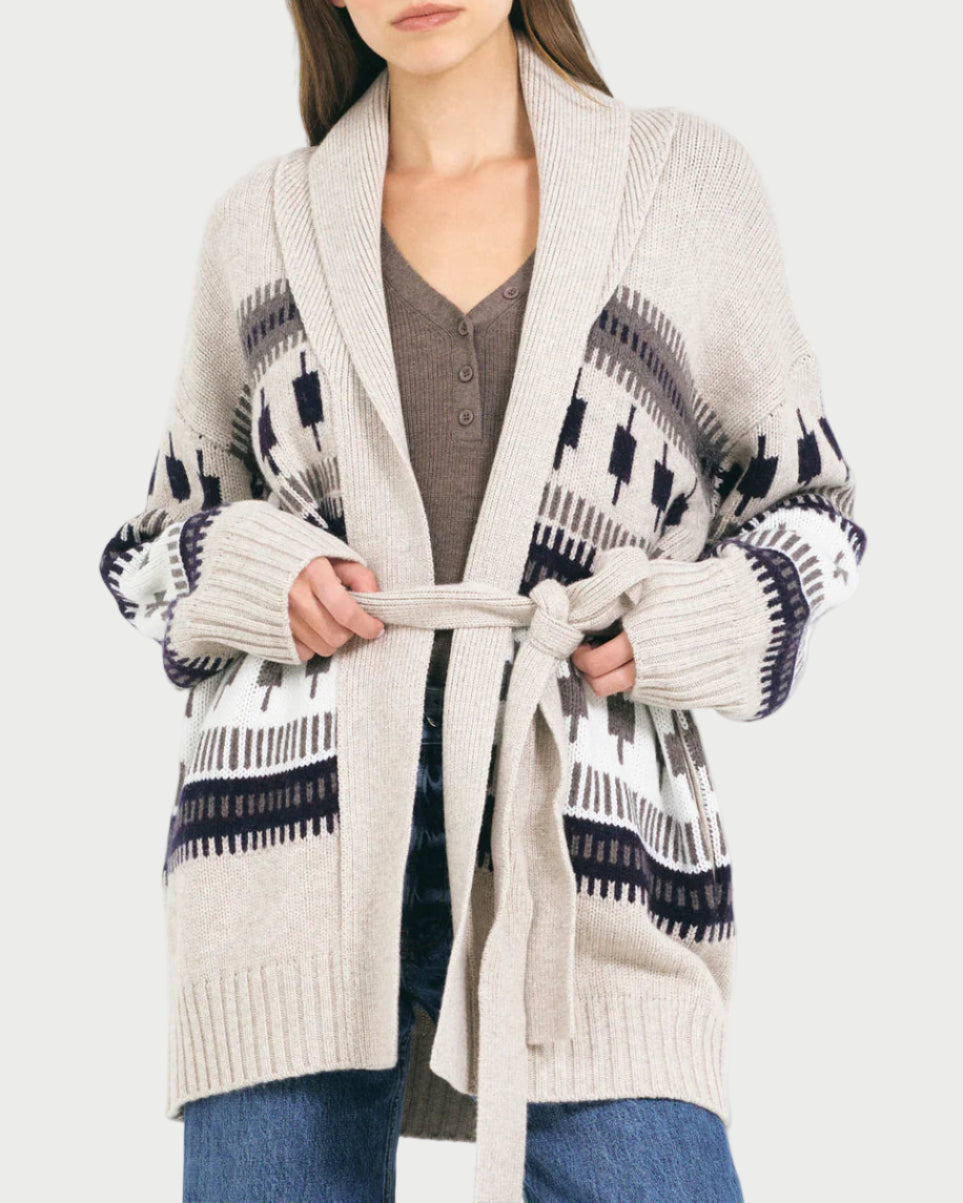 Woman wearing a patterned cardigan on a white background