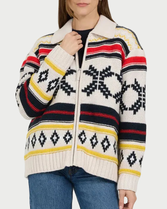 Woman wearing a patterned sweater and blue jeans on a white background