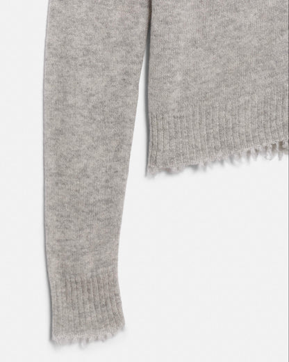 Gray knitted scarf with frayed edge on a white background