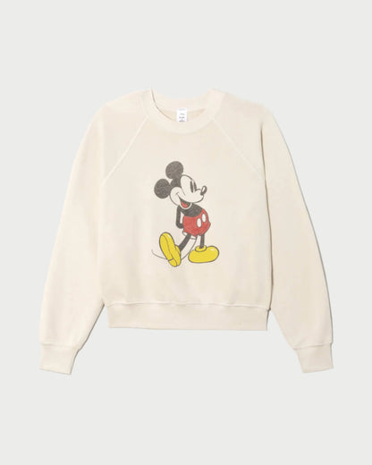 The RE/DONE Classic Crewneck Mickey Mouse is a cream French terry sweatshirt featuring a vintage-style graphic of Mickey standing and smiling in red shorts and yellow shoes, centered on the front.