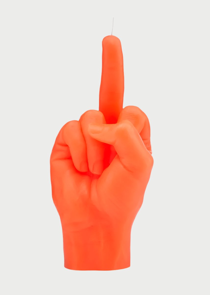 A bright orange candle shaped like a human hand making a rude gesture sets the perfect mood. With its middle finger extended upward and other fingers folded down, this unmistakable F*ck You Candle Hand by 54° Celsius has the wick located on the tip of the middle finger.