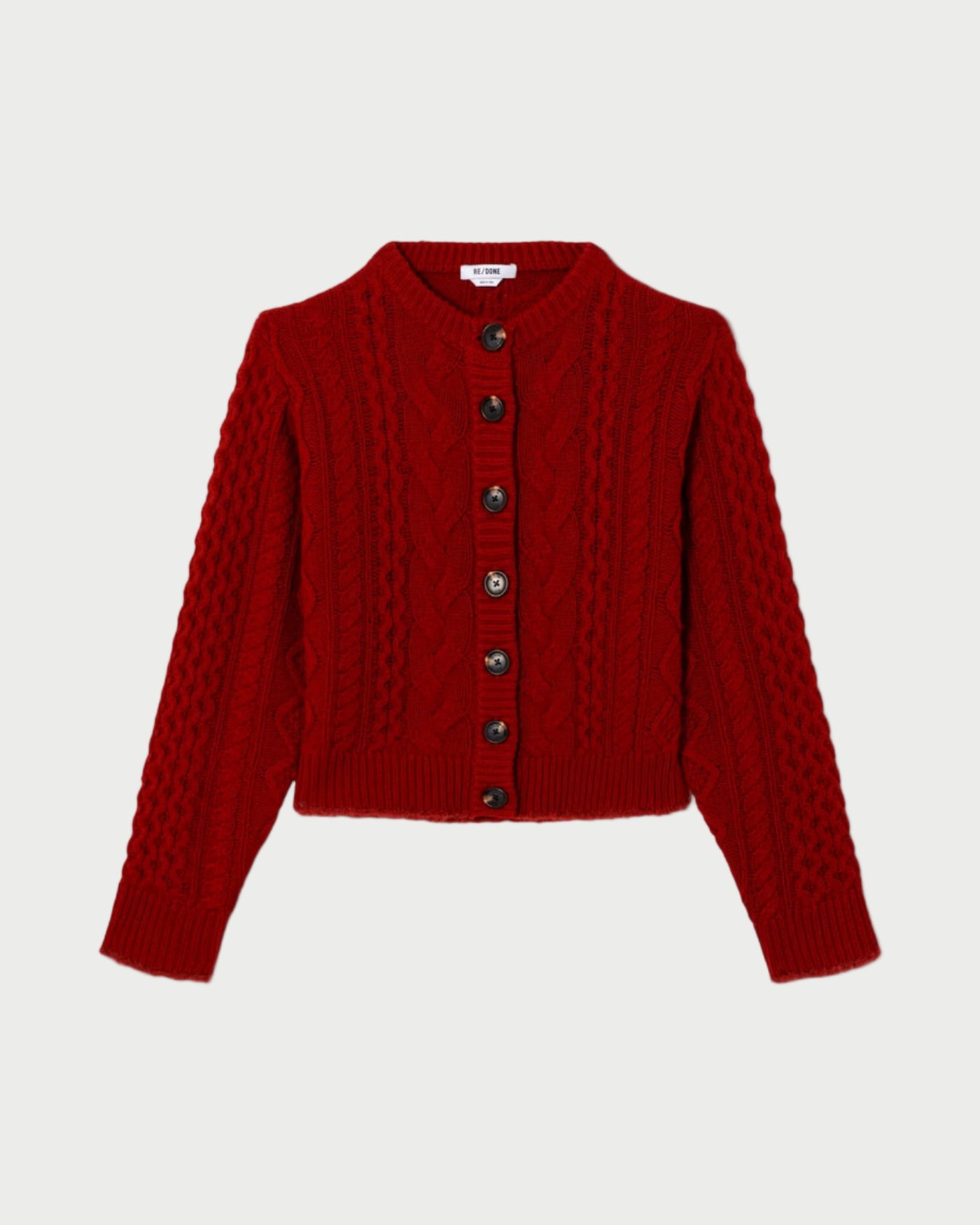 Red knitted cardigan on a white background