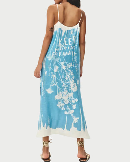 Woman wearing a blue floral dress with 'KEEP CALM' text on a white background