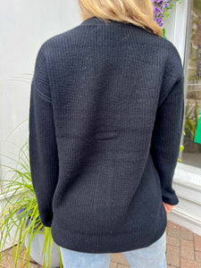 Black front button cardigan, available at west2westport.com