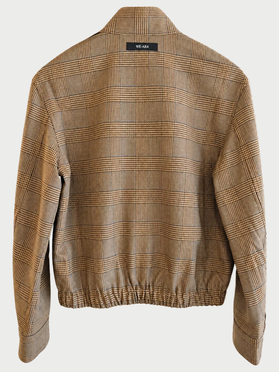 Back view of the limited edition WE-AR4 B Bomber by WE-AR4, featuring a beige plaid design, long sleeves, elasticated hem, and a small black label with white text near the collar, expertly crafted from upcycled wool.