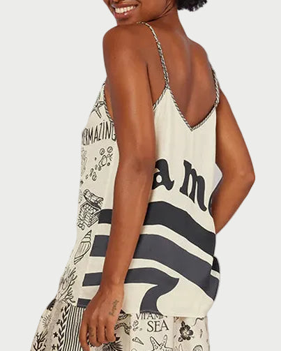 Woman wearing a patterned camilsole with a desert landscape in the background