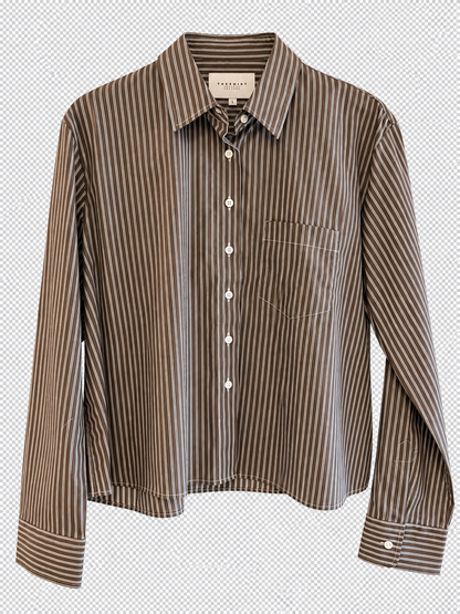 The Shirt Long Sleeve Stripe Boxy Crop by The Shirt is a modern brown and white vertically striped button-up shirt, featuring long sleeves, a single chest pocket, a spread collar, white buttons with no gape technology—all displayed on a transparent background.