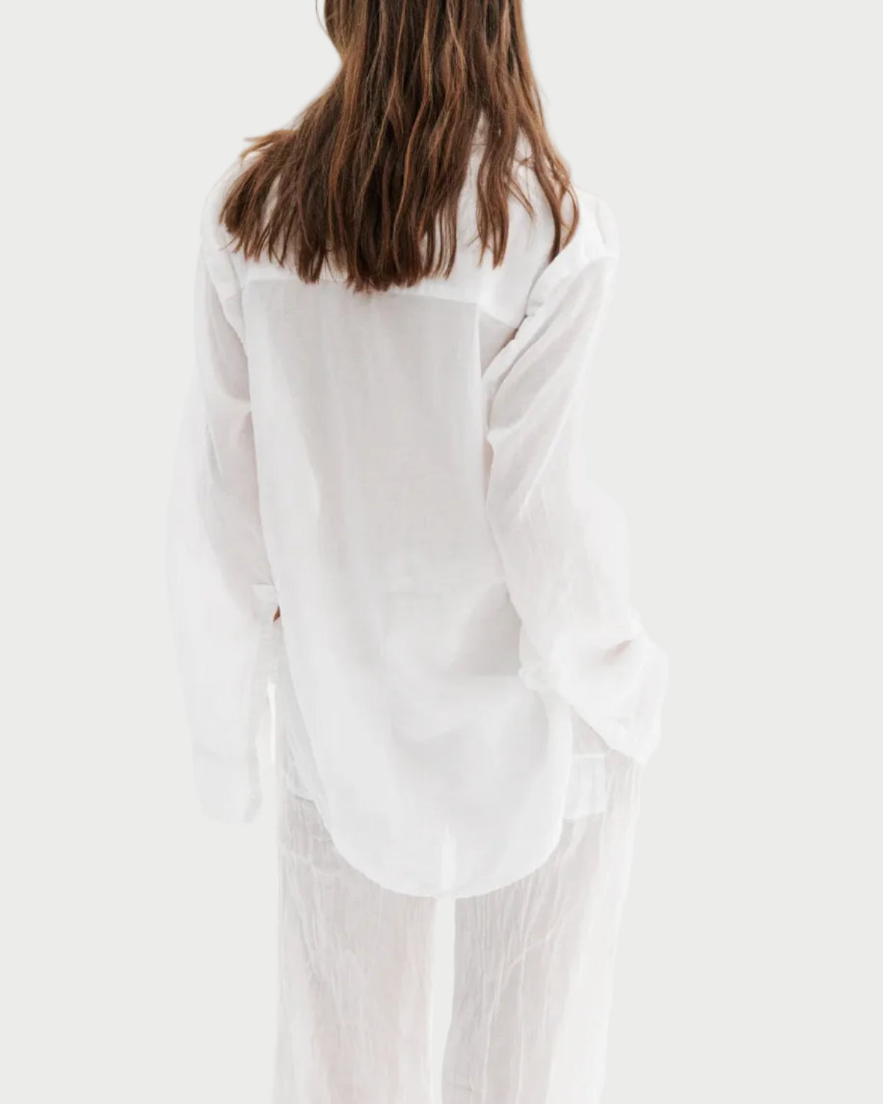 Person wearing a white outfit on a white background