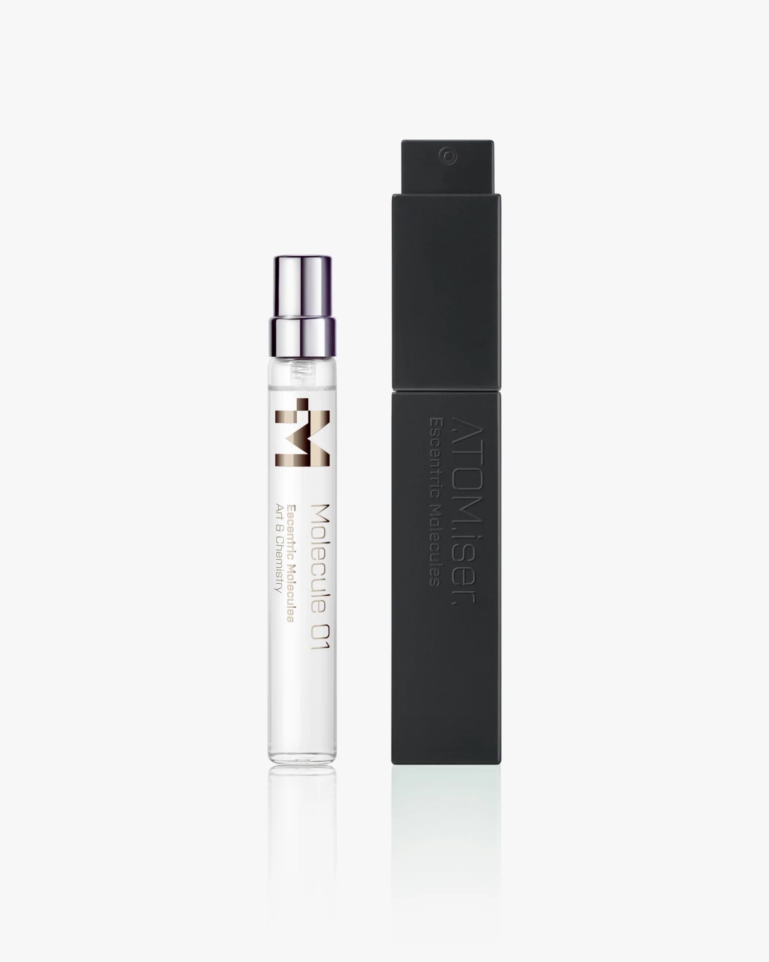 A clear Escentric Molecules Atomizer vial with a silver cap stands beside a tall, black, travel-sized case labeled "ATOMISER" on a white background.