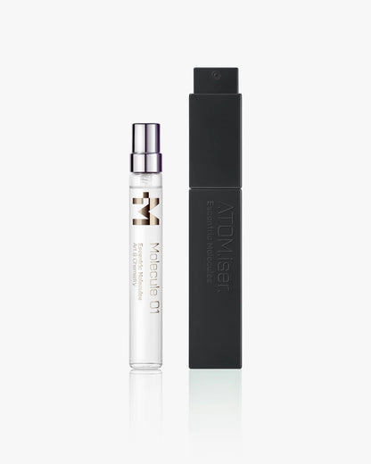 A clear Escentric Molecules Atomizer vial with a silver cap stands beside a tall, black, travel-sized case labeled "ATOMISER" on a white background.
