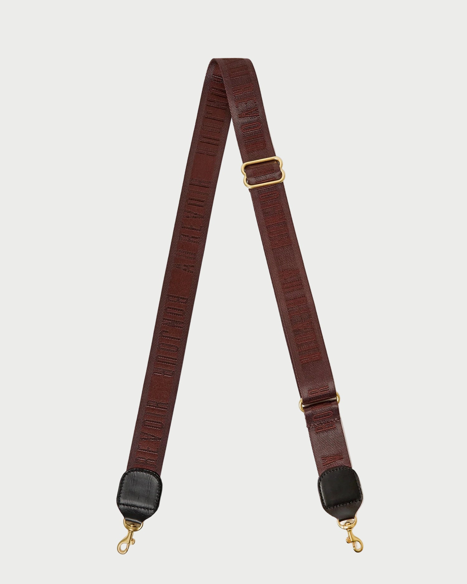 Brown leather strap with gold hardware on a white background