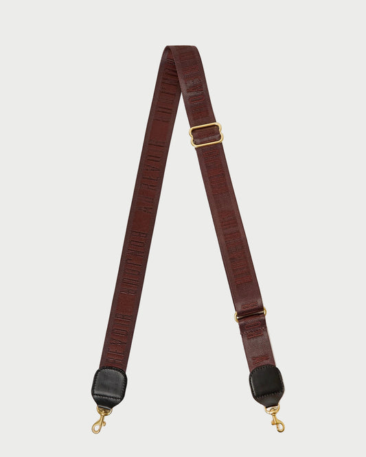 Brown leather strap with gold hardware on a white background