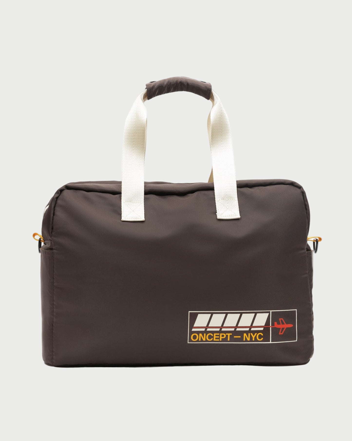 The Oncept Olympia Travel Bag is a dark brown duffel with white handles, a yellow "ONCEPT – NYC" logo, and a red airplane graphic on the lower corner, shown against a plain light backdrop.