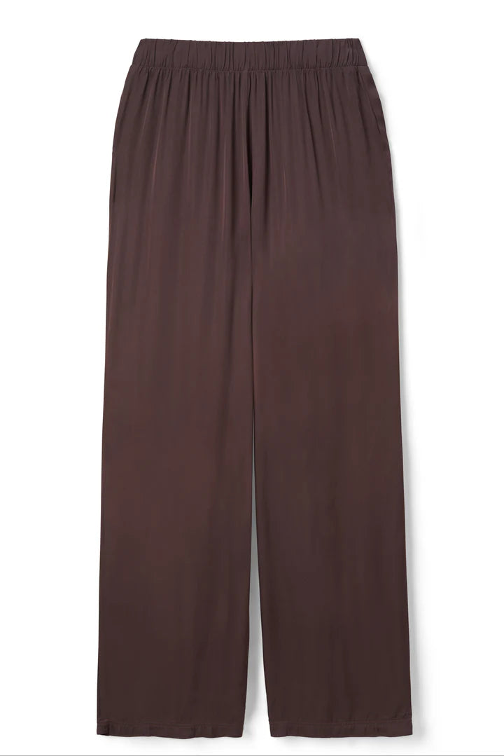 The Camile Satin Wide Leg Pant by perfectwhitetee features a loose, mid-rise fit in dark brown satin with an elastic waistband and wide legs, shown laid flat on a white background.