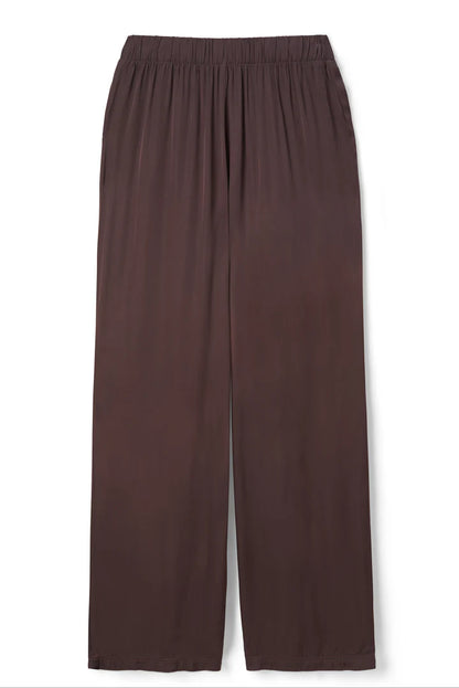 The Camile Satin Wide Leg Pant by perfectwhitetee features a loose, mid-rise fit in dark brown satin with an elastic waistband and wide legs, shown laid flat on a white background.