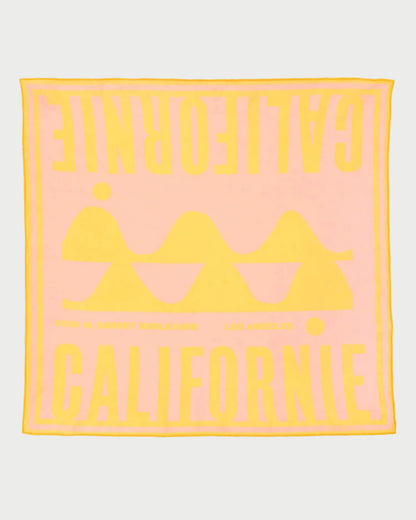 Pink towel with yellow text and logo on a white background