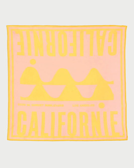 Pink towel with yellow text and logo on a white background