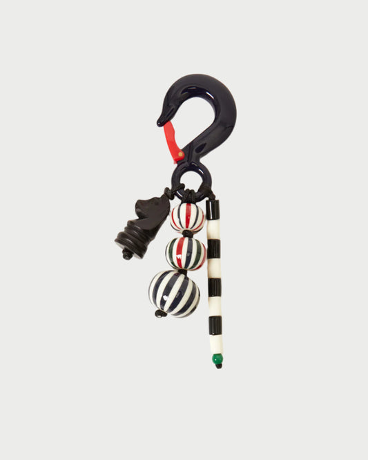 Add a unique touch to your bag with the CLARE V. Beaded Stripe Fob Bag Charm, featuring a black chess knight charm, striped round beads, and a dark hook—a decorative accessory that stands out.