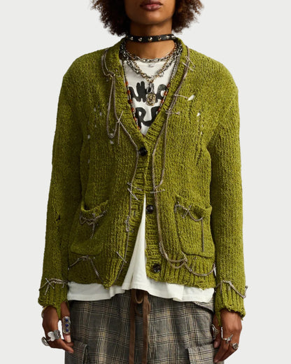 Person wearing a green textured jacket with a plain background