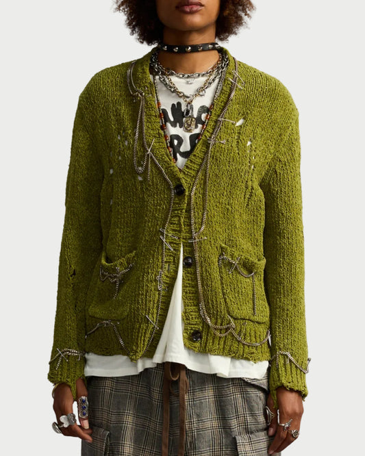 Person wearing a green textured jacket with a plain background