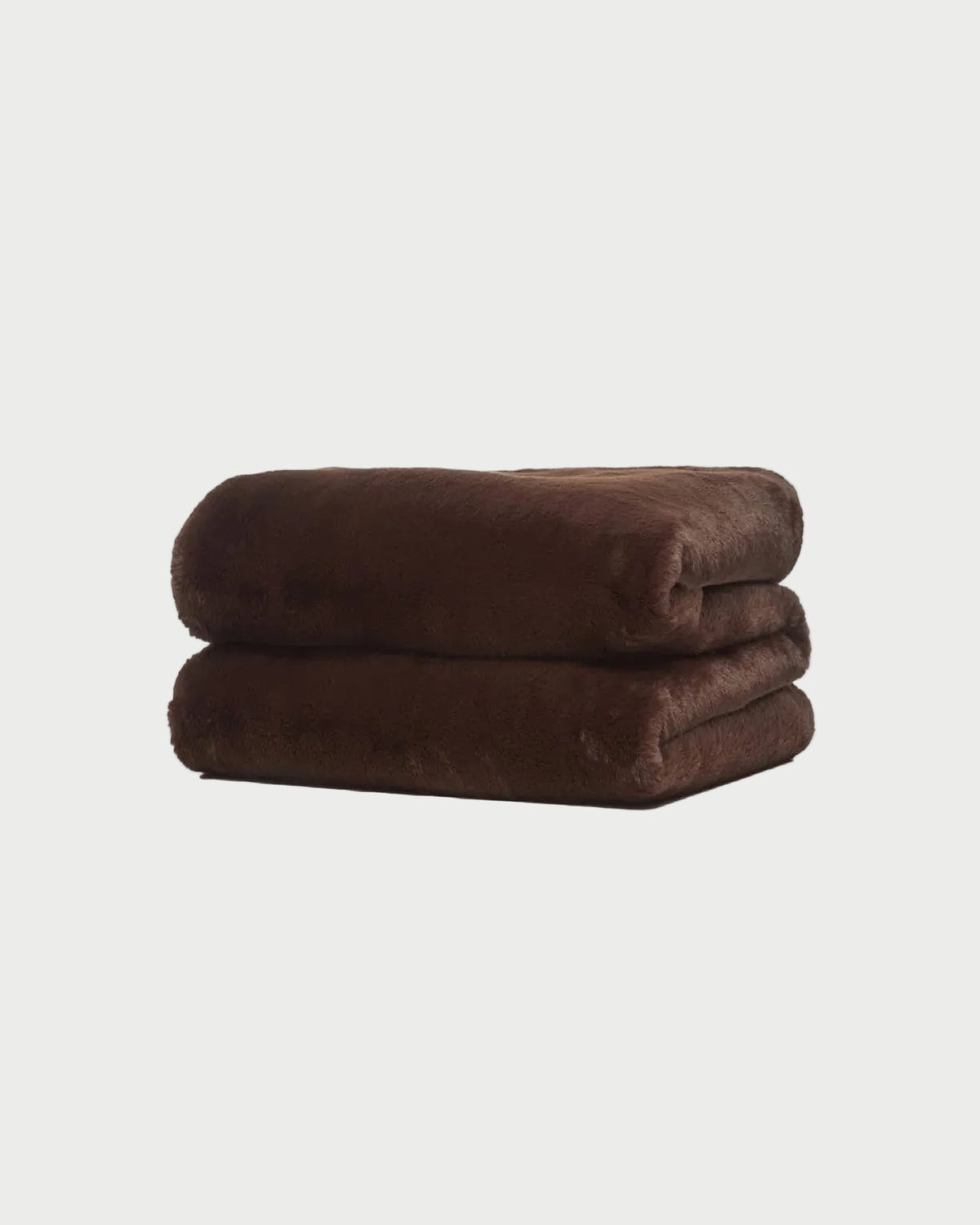 A folded, dark brown APPARIS Brady Blanket made of faux fur.