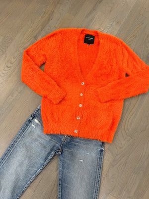 bright orange Le Suberbe boyfriend sweater and Moussy Ridgemont jeans at westport ct women's clothing store WEST and online at west2westport.com
