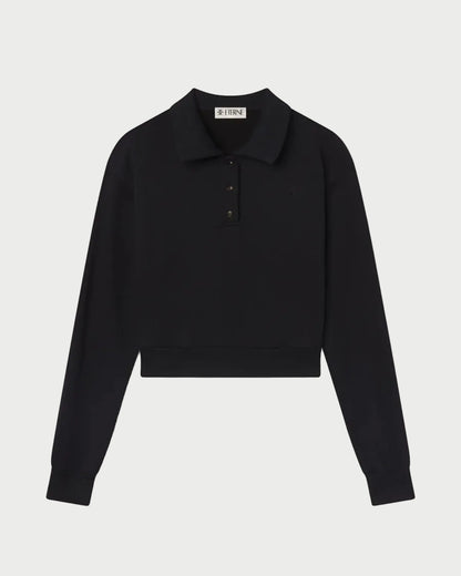 The Éterne Cropped Polo Sweatshirt by Eterne is a black, long-sleeve cropped sweatshirt featuring a collar and three buttons at the top. Crafted from soft French terry for a relaxed fit, it is displayed on a white background.