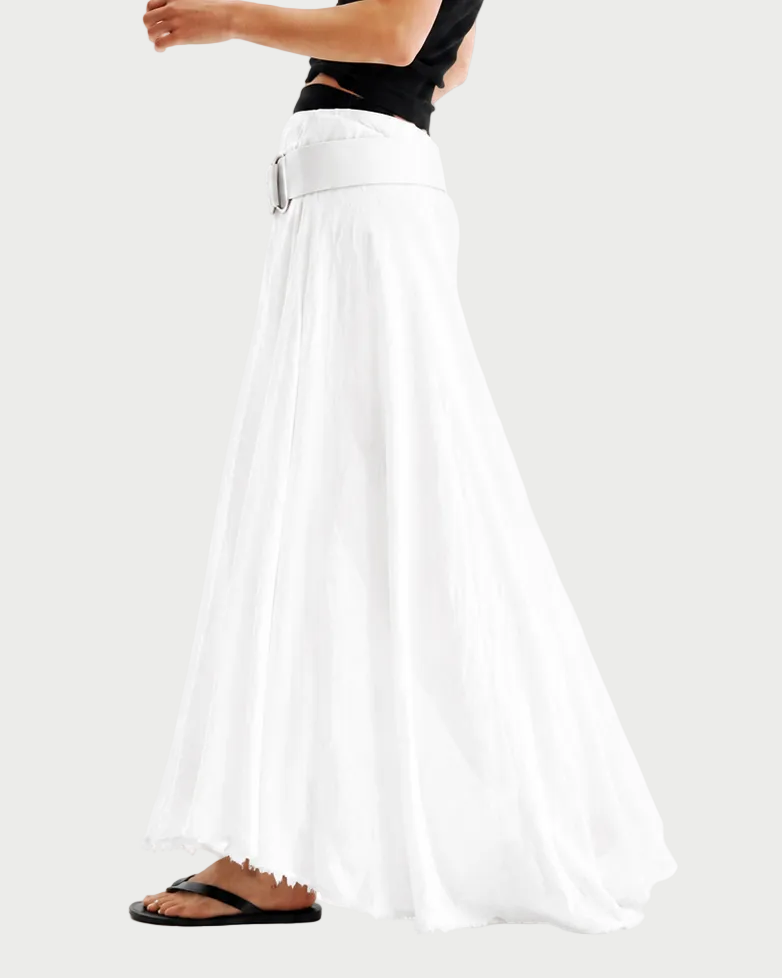 Woman wearing a black top and white pants on a white background